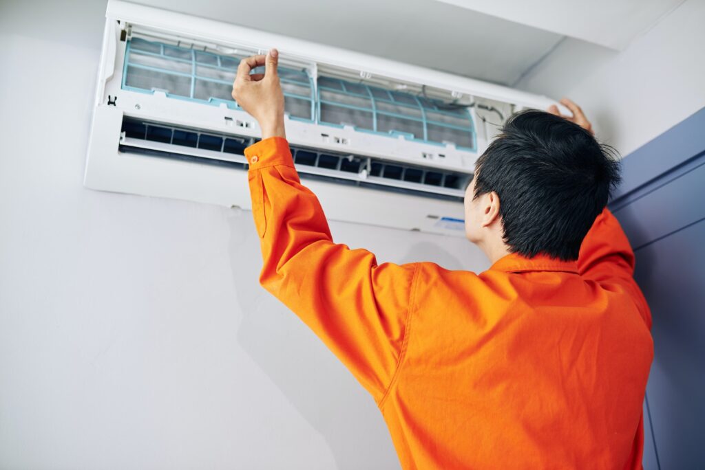 Technician installing conditioner
